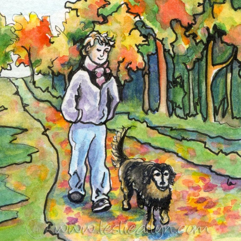 man and dog walking in fall autumn leaves