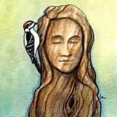 woodpecker downy bird pecks the head of a wooden woman on green
